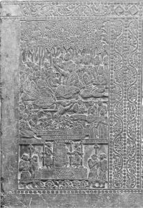 图18 安阳粟特墓出土的石屏，创作年代可能是北齐（550—577）。画面中，葡萄架下正在举行庆祝活动，一串串葡萄沉甸甸地挂在枝头，一位身穿中亚风格盛装的男性坐在正中间，手举华美的角杯饮酒